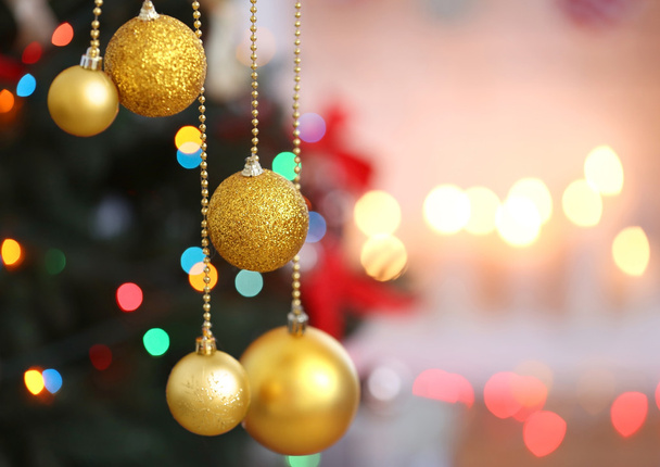 Beautiful balls on blurred Christmas lights background, closeup - Fotografie, Obrázek