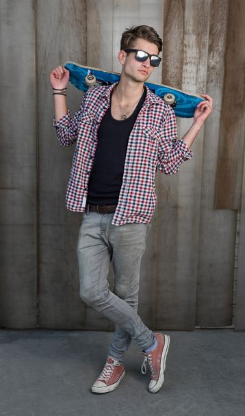 Young fashion guy with a skateboard - Zdjęcie, obraz
