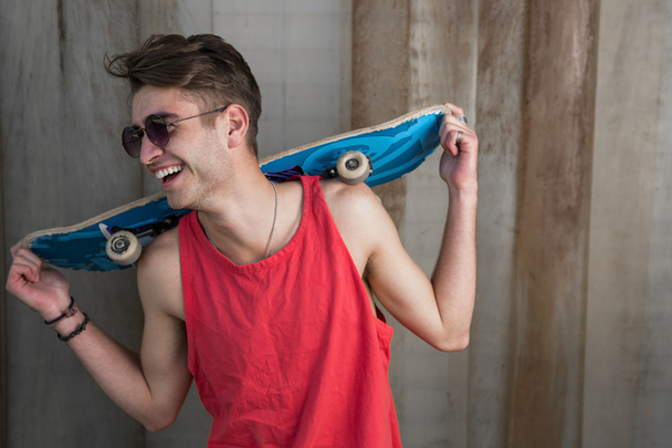 Young fashion guy with a skateboard - Фото, изображение