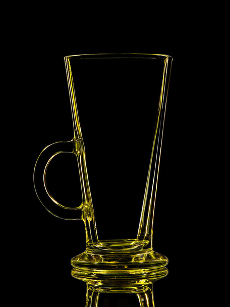 Silhouette of yellow glass for shot on black - Фото, зображення