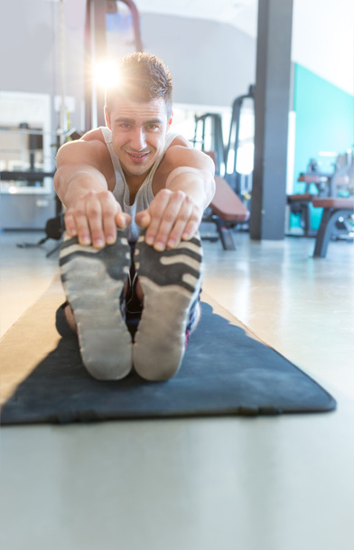 athlete stretching in gym - Фото, зображення
