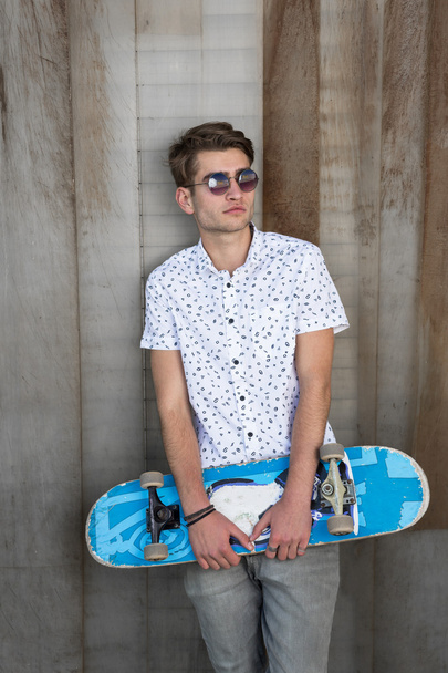 Young fashion guy with a skateboard - Фото, зображення