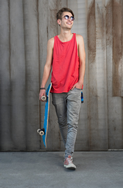 Young fashion man with skateboard - Foto, Imagen