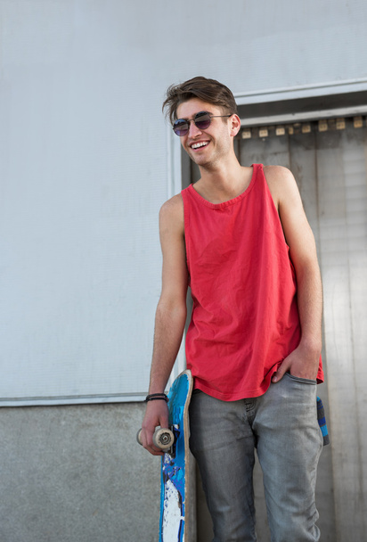 man with blue skateboard - 写真・画像