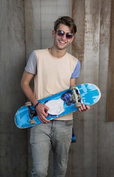 smiling man with skateboard - 写真・画像