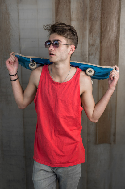 Young fashion guy with a skateboard - Фото, изображение