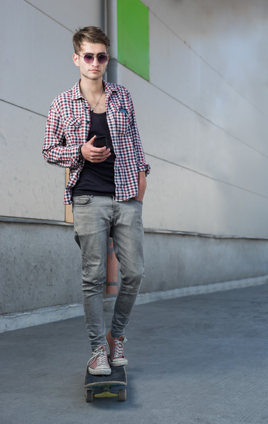 Young hipster man with skateboard - Foto, imagen