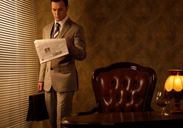 Retro businessman reading newspaper - Photo, Image
