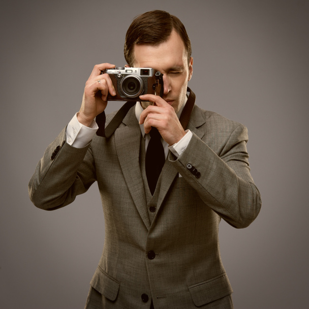 Businessman with a retro camera - Photo, Image