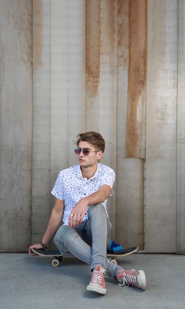 Young fashion guy with a skateboard - Фото, зображення