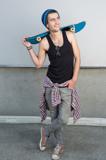 Young fashion guy with a skateboard - 写真・画像