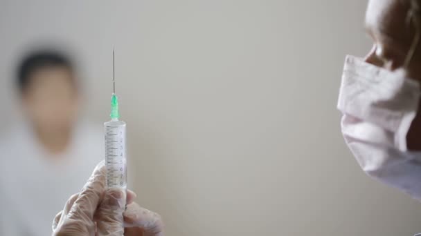 Cute little boy afraid of injection. nurse prepares a syringe - Felvétel, videó
