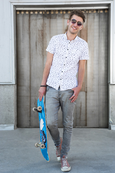 Young fashion guy with a skateboard - Photo, Image