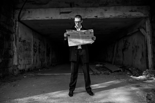guy in a white shirt and black coat reading a newspaper - Photo, Image