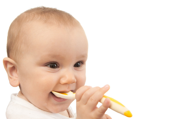 Baby feeding himself with spoon - 写真・画像
