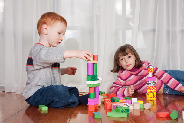 Kids playing with wooden blocks - Foto, Imagen