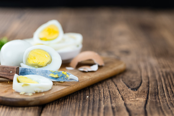 Sliced eggs on old wooden table - Photo, Image