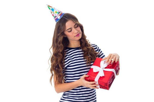 Woman in celebration cap holding a present - Photo, Image