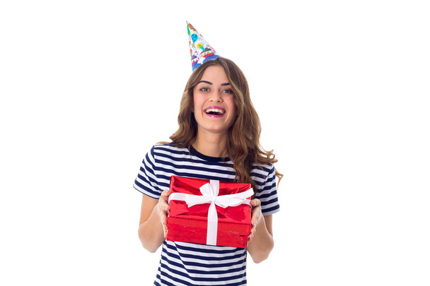 Woman in celebration cap holding a present - Foto, Imagem