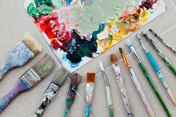 Brushes with palette in the creative background. Colorful element. - Photo, image