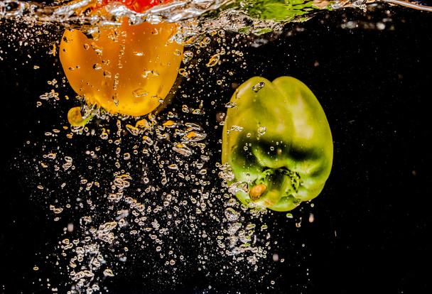 splashing bell peppers on water - Photo, Image