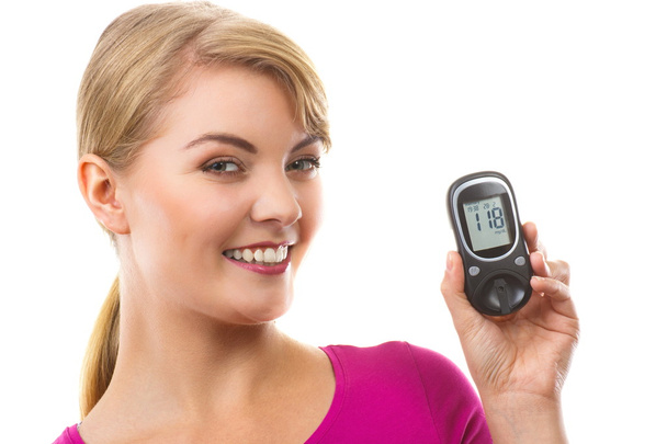 Happy woman holding glucometer, checking and measuring sugar level, concept of diabetes - Photo, Image