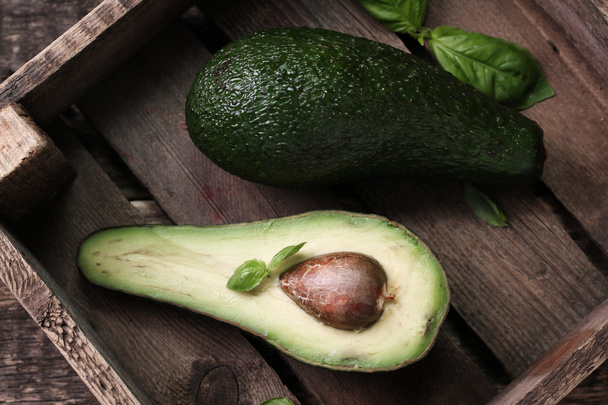 food background with fresh organic avocado on old wooden table, top view, copy space - Photo, Image