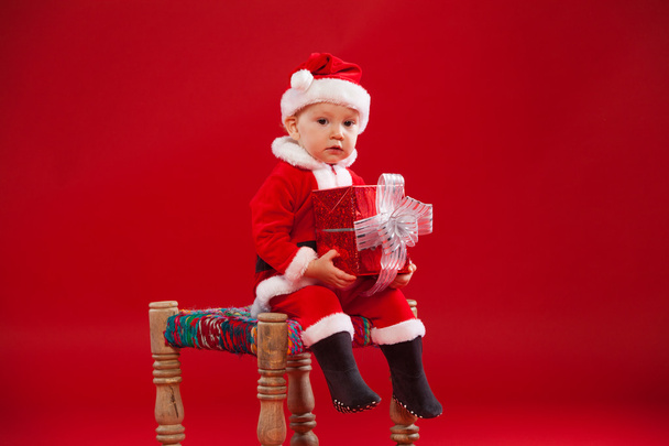Beautiful little baby celebrates Christmas. New Years holidays. with gift - Φωτογραφία, εικόνα