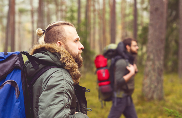 Young men hiking in forest  - Fotó, kép