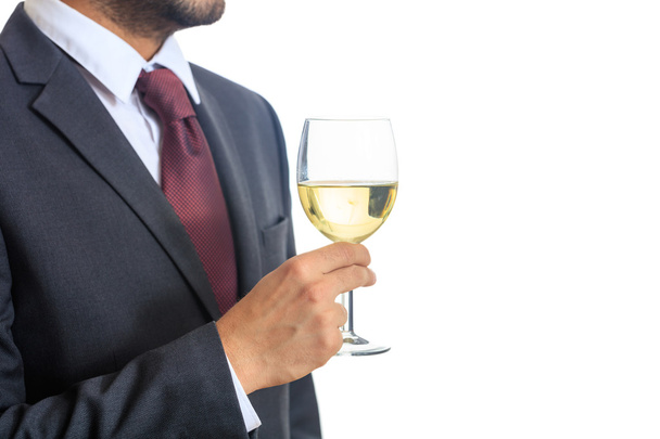 Чоловік у костюмі п'є біле вино
 - Фото, зображення