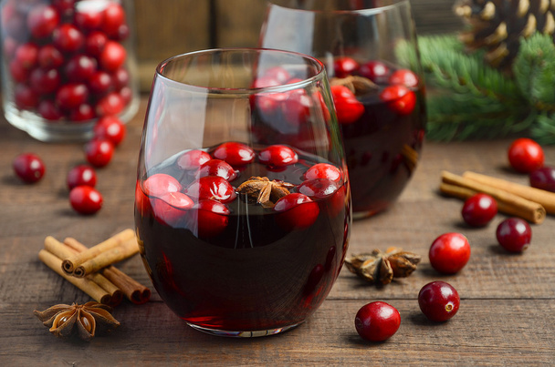 Mulled red wine in a glass on a wooden table - Fotó, kép