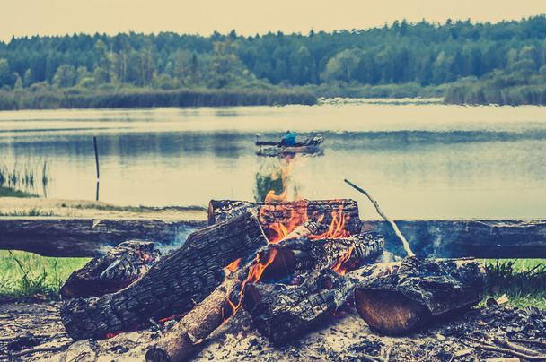 Rustic bonfire by the lake, autumn landscape - Fotoğraf, Görsel