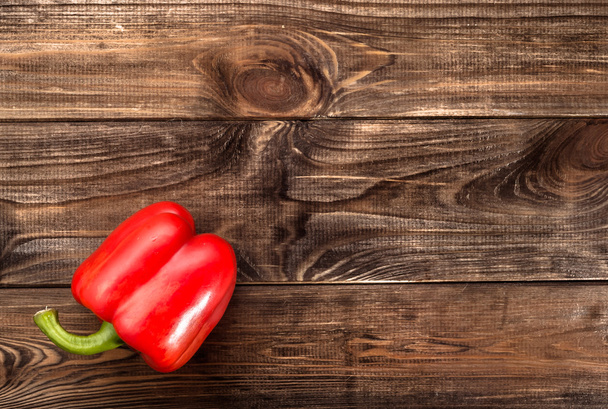 Red paprika on rustic wooden background, top view  - Fotó, kép