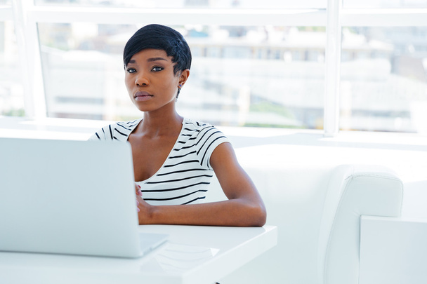 Portrait of a casual young african businesswoman using laptop computer - Fotó, kép