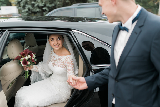 portrait of the happy bride and groom in the car - Photo, Image