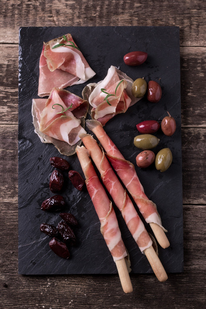 Curled Slices of Delicious Prosciutto with spice  Italian cuisine  - Photo, Image