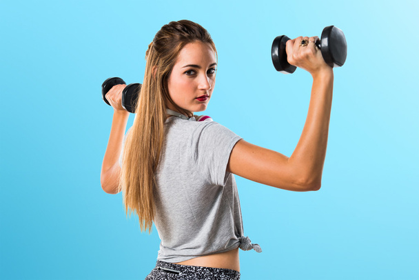 Young woman doing weightlifting - Фото, зображення
