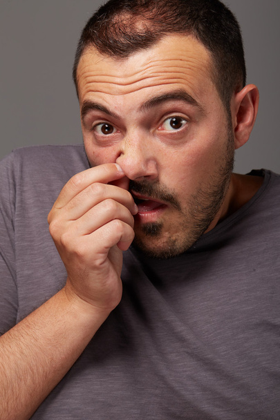 young man with finger in his nose - Photo, Image