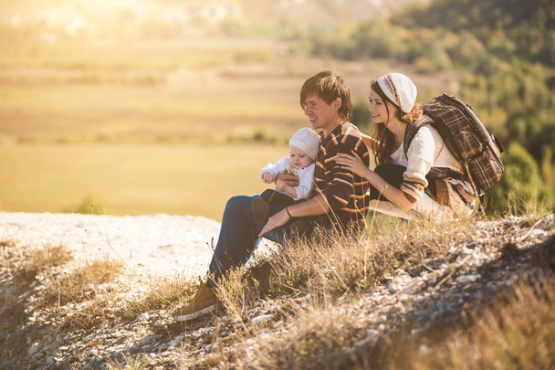 Young parents with kid on the mountains - Foto, imagen