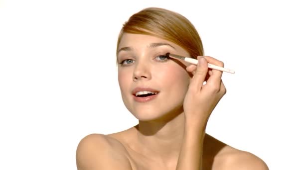 Portrait of beautiful and sexy woman is doing makeup - Felvétel, videó