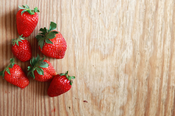 strawberries top on wooden background - Photo, Image