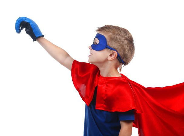 Superhero kid in costume posing isolated on white background - 写真・画像