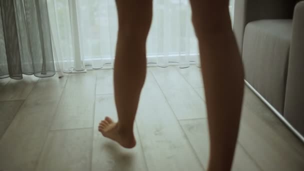Lady walking barefoot at home. - Felvétel, videó