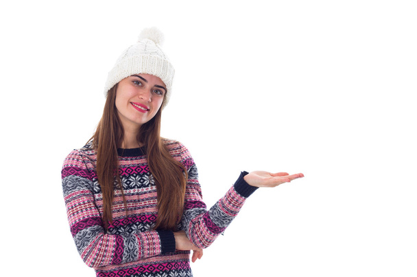 Woman in sweater and white hat holding something - Photo, Image