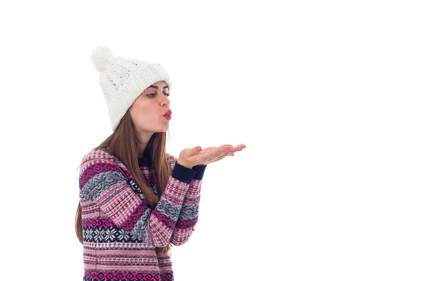 Woman in sweater and white hat blowing - Photo, Image