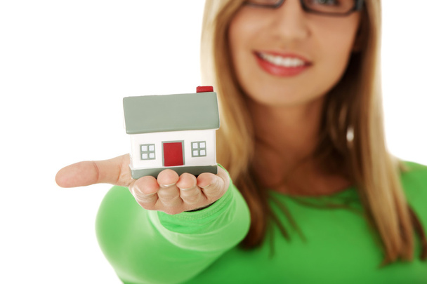 Young casual woman holding house model - Photo, Image