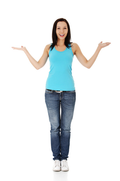 Casual woman presenting something on her heand - Photo, Image