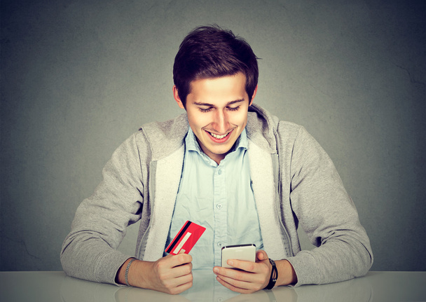 Man holding credit card using smart phone for internet shopping - Fotografie, Obrázek
