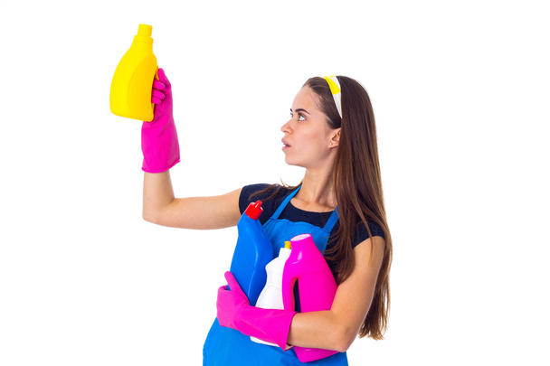 Woman in apron holding a detergents - Photo, Image