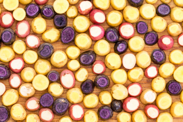 Sliced and topped mini baby potato background - Foto, afbeelding